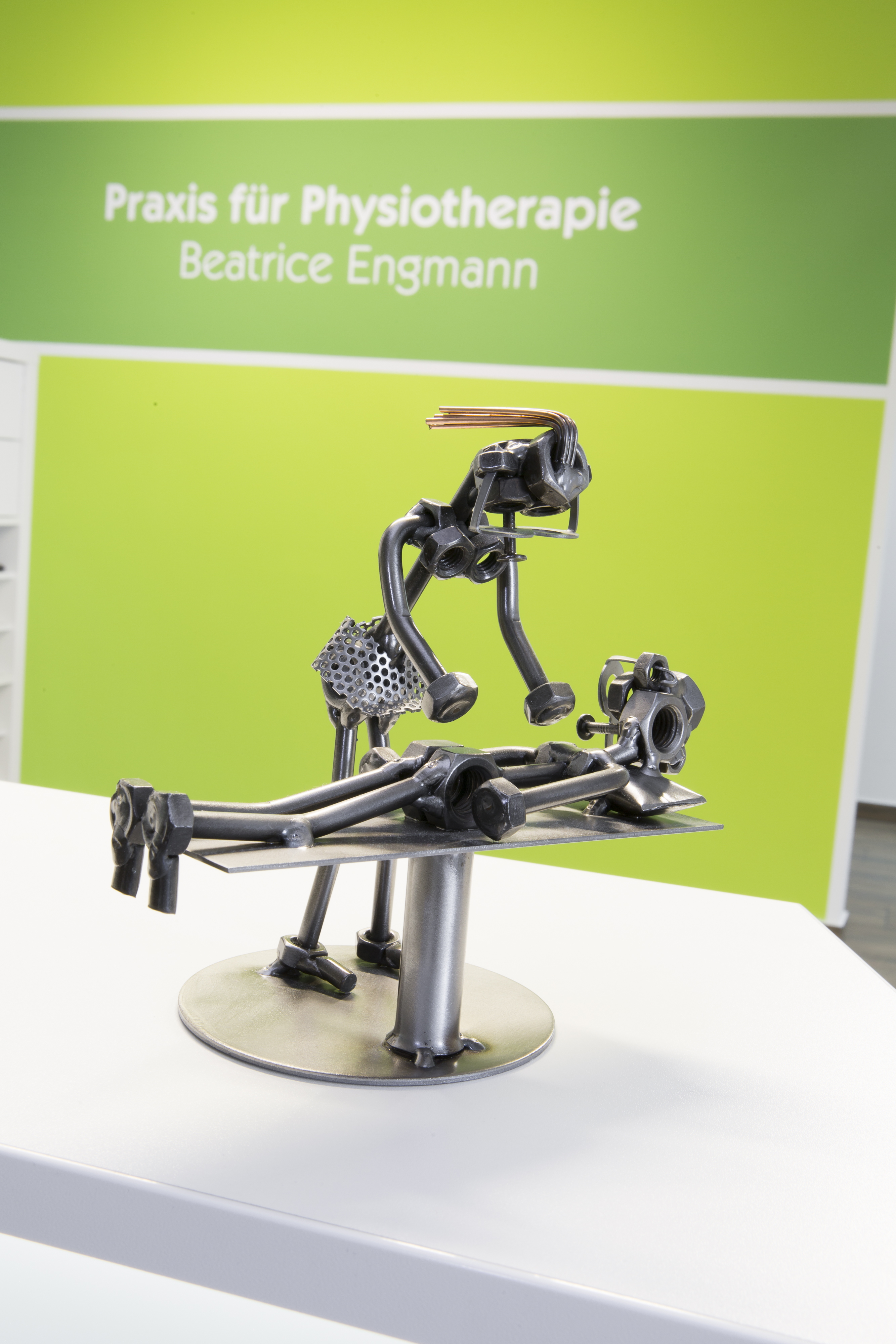 Kleine Metallfigur bei einer physiotherapeutischen Behandlung